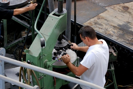 guy in white shirt operating heavy machinery
